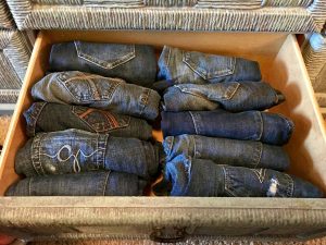 Photo of jeans folded and placed upright in drawer, the KonMari method