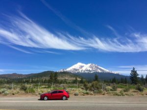 My red Mazda in front of Mount Shasta. I used some great packing hacks to fit in everything I needed!
