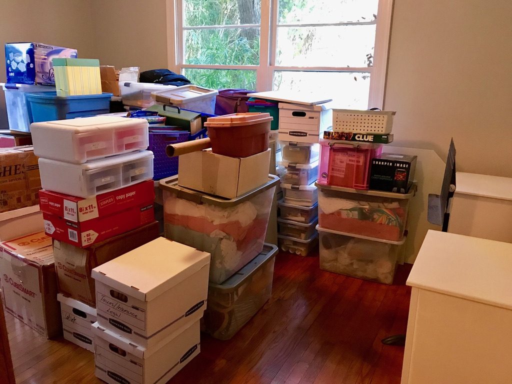 Office with stacks of various moving boxes