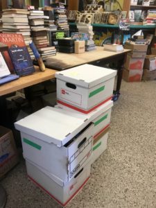 Five bankers boxes of books waiting for review and purchase at Chamblin's Bookmine